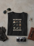 Nature Over Notifications Black oversized T-shirt laid flat on studio canvas, full-scale 43.7% torso DTG print.