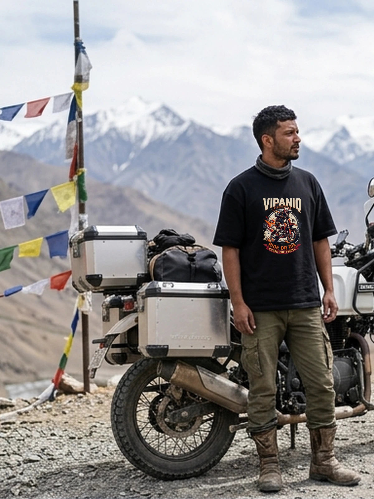 Kabir wearing Ride Or Die Chase The Thrill oversized black T-shirt with calibrated chest DTG print at high Himalayan mountain pass.